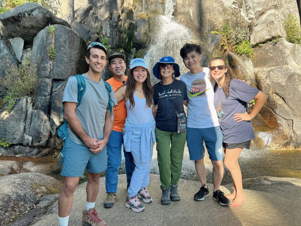 Group photo in front of a waterfall.